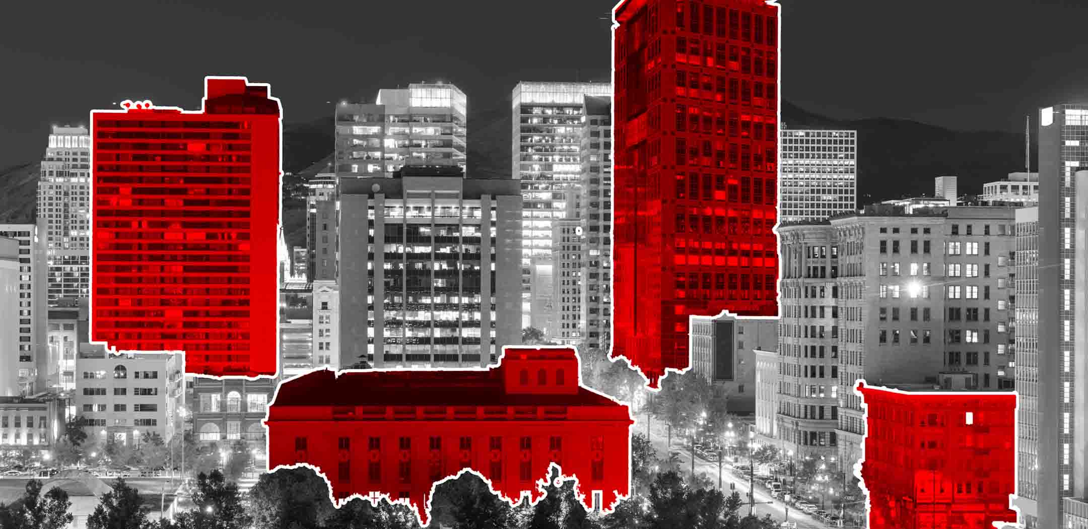 An image of a part of Salt Lake CIty UT's cityscape in black and white with select buildings highlighted in red to demonstrate the selective nature and capabilities of geofencing marketing.