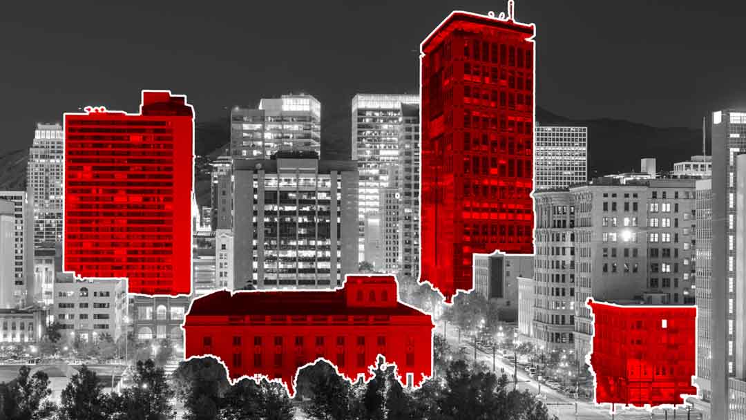 City skyline with highlighted red buildings, symbolizing a geofencing marketing company's impact on business growth.